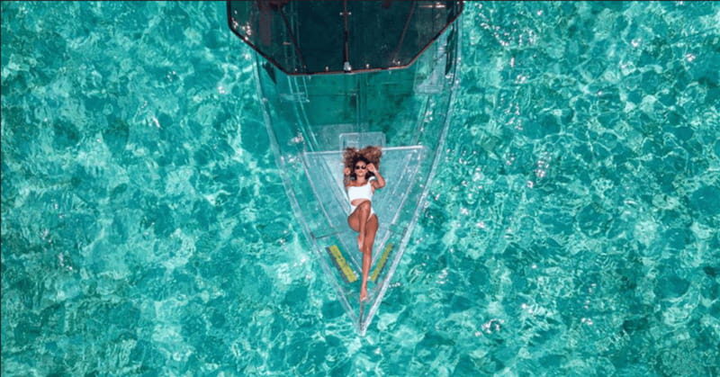 Explore the sea of cozumel in a transprent boat with drinks and snorkel. - San Miguel approach: pier views, a diver monument, and the underwater payoff