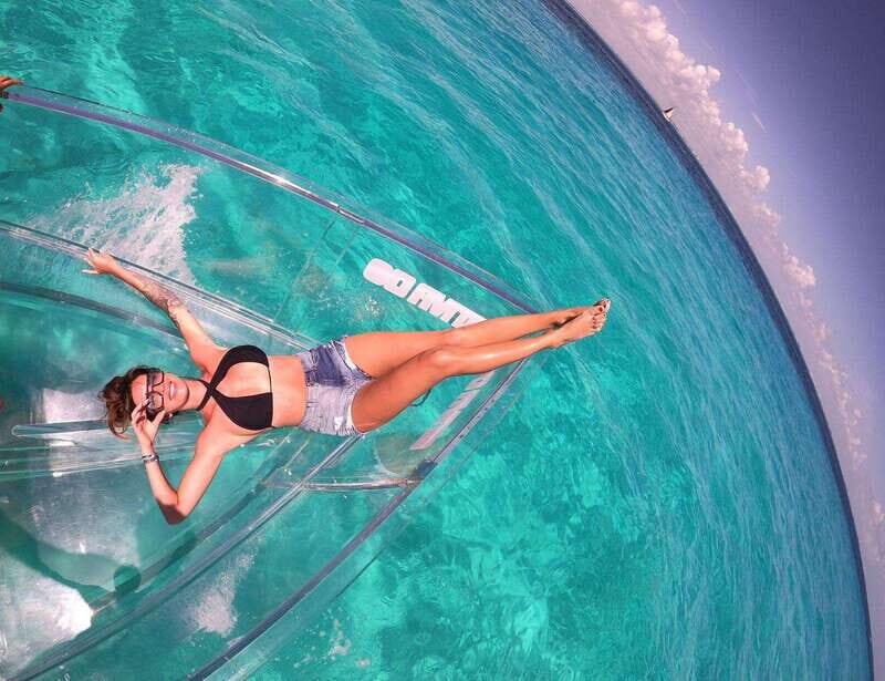 Explore the sea of cozumel in a transprent boat with drinks and snorkel. - The Lego artificial reef snorkeling stop: what optional snorkeling really means