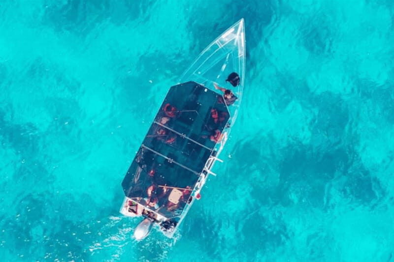 Explore the sea of cozumel in a transprent boat with drinks and snorkel. - Two complimentary drinks: small perk, real comfort on the water