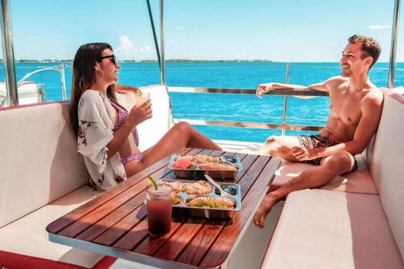 Isla Mujeres Plus Experience Catamaran Tour + Snorkel+Lunch - The return cruise at sunset, plus the Spinnaker if conditions allow